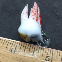 Pulled tooth pendant